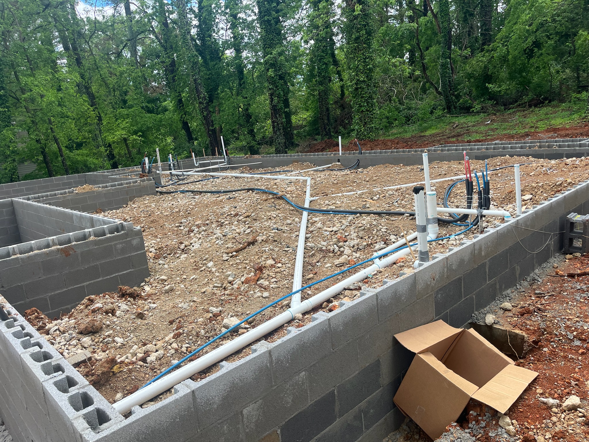 Foundation block and plumbing in place at Hilltop Terrace.